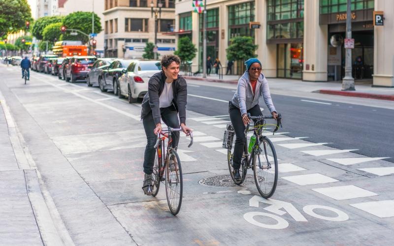 Find your perfect fit at Jaide Lofts a couple of people riding bikes on a street