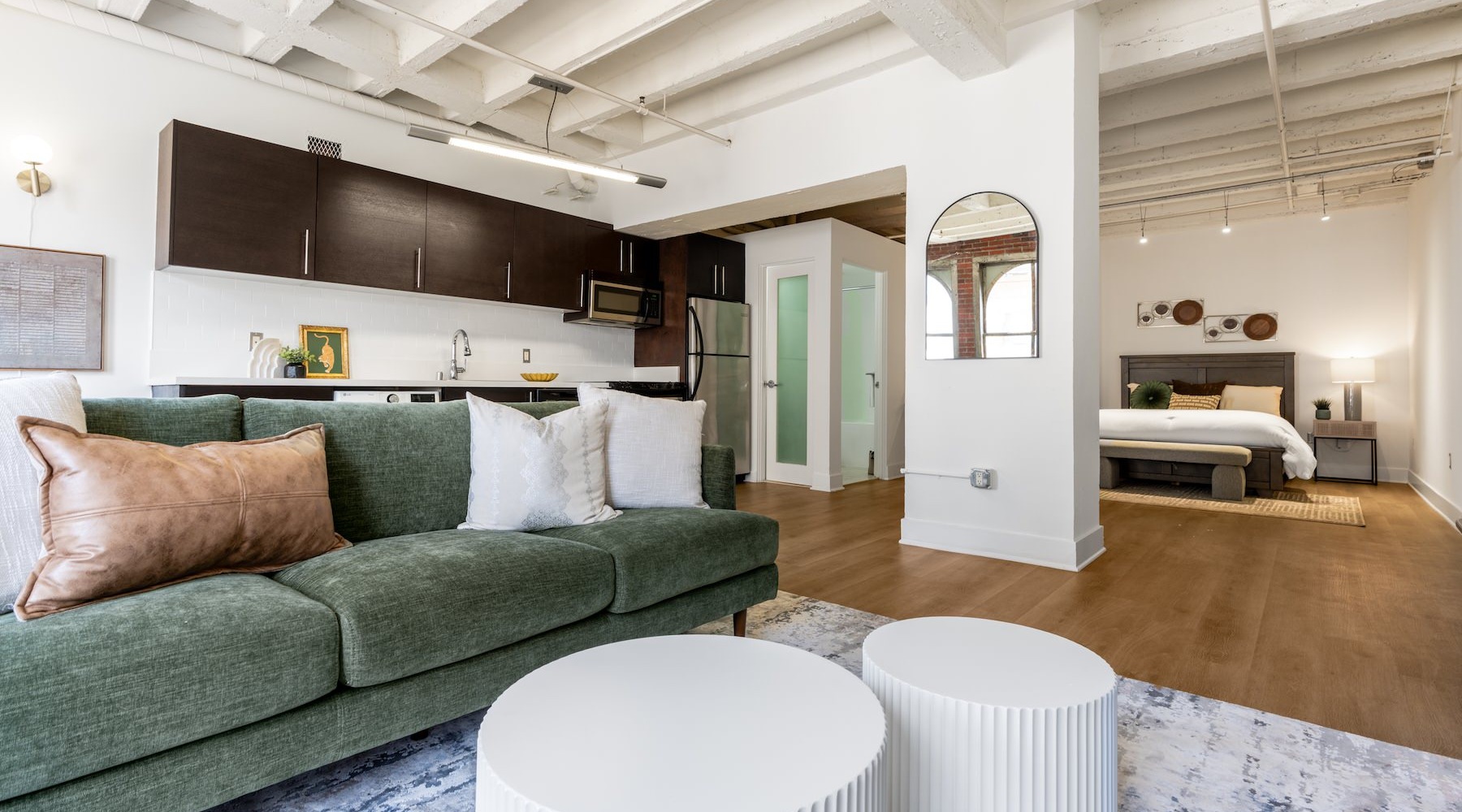 Beautiful living areas to match your lifestyle a studio apartment with a couch, a bed and a kitchen