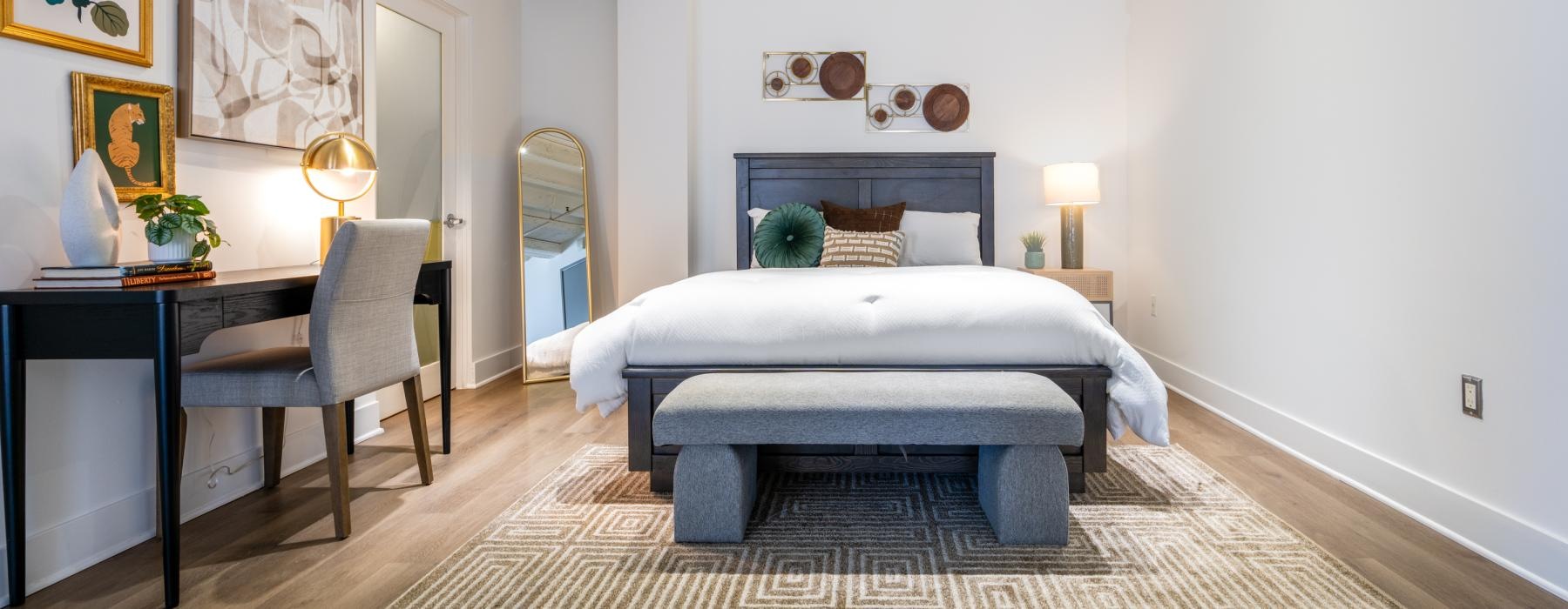 a bedroom with a bed and a desk