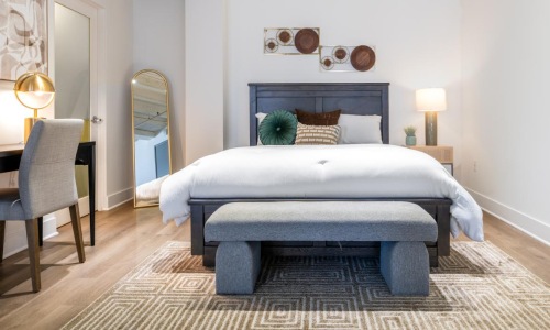 a bedroom with a bed and a desk