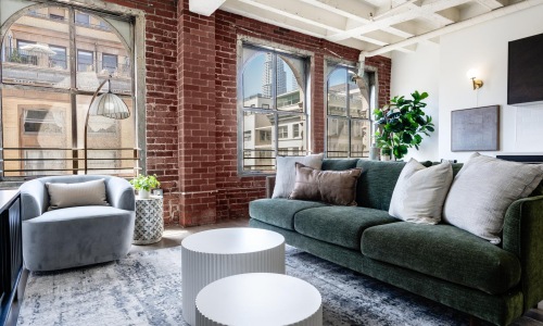 a living room with a brick wall