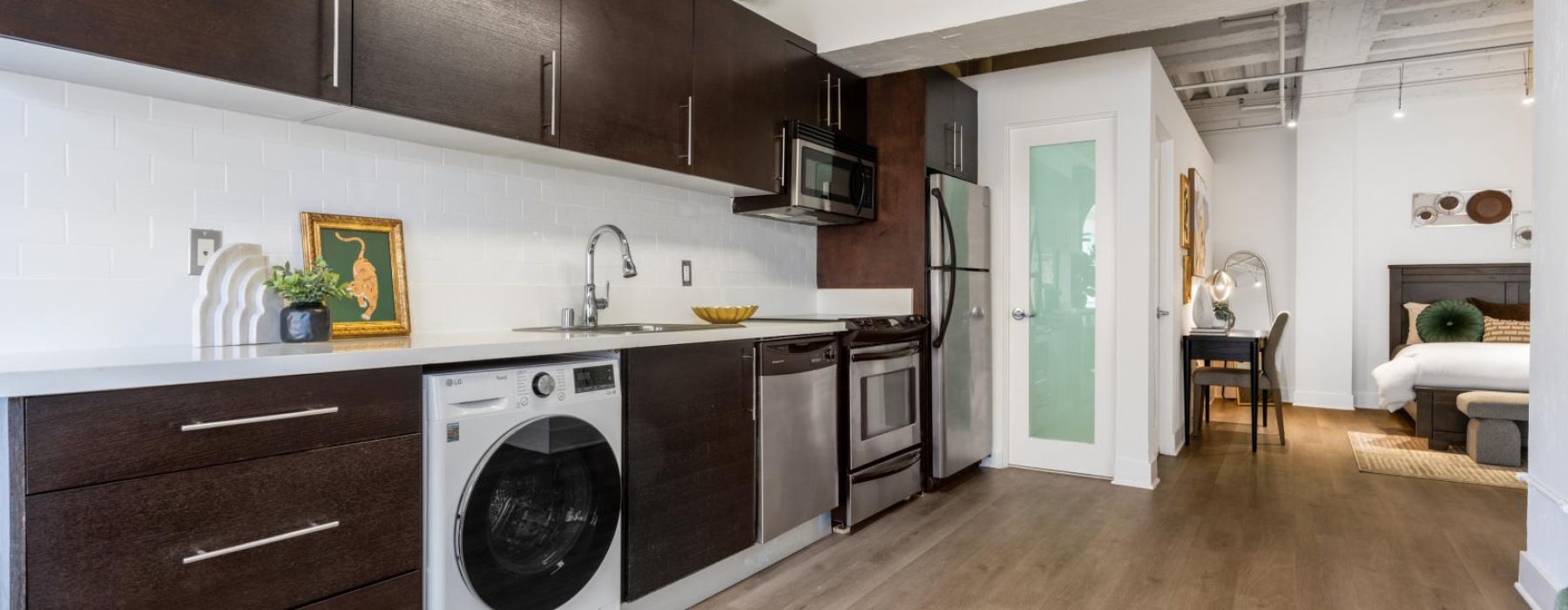 a kitchen with dark cabinets