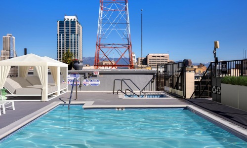 a pool with a slide in the background